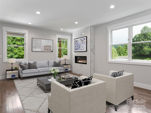 living area with recessed lighting, baseboards, and wood finished floors