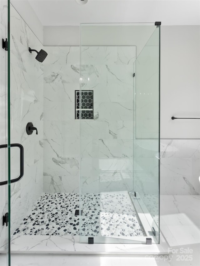 full bathroom with a marble finish shower