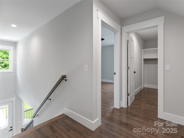 corridor featuring recessed lighting, dark wood-type flooring, an upstairs landing, baseboards, and vaulted ceiling