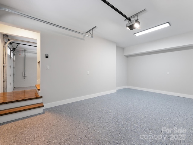 garage featuring baseboards and a garage door opener