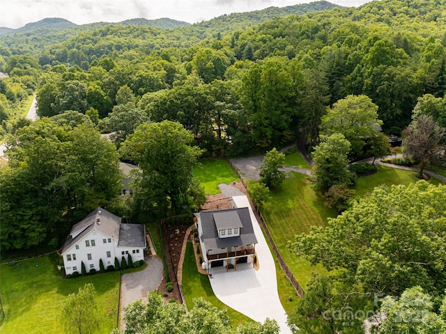 bird's eye view featuring a wooded view