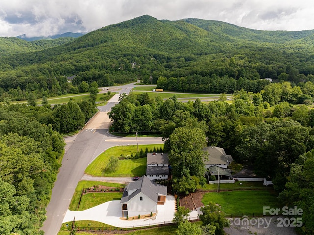 drone / aerial view featuring a forest view and a mountain view