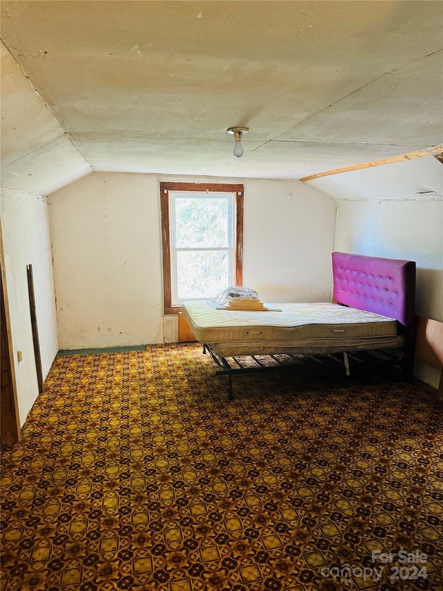 unfurnished bedroom with lofted ceiling