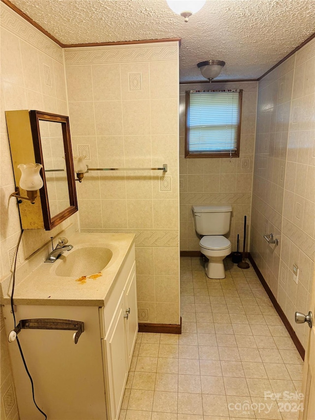 bathroom featuring tile walls, vanity, and toilet