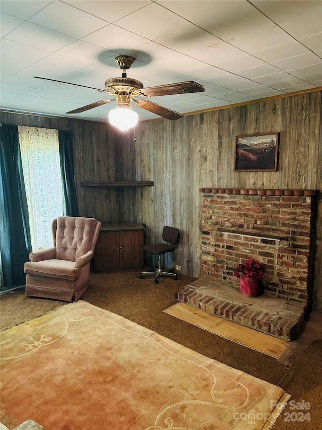 living room featuring wood walls and carpet floors