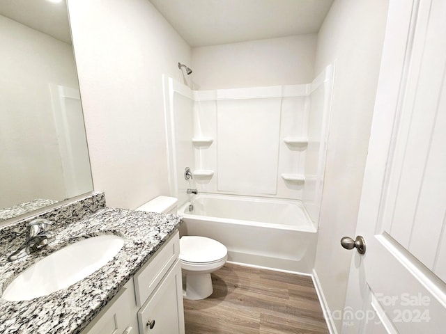 full bathroom with  shower combination, toilet, hardwood / wood-style floors, and vanity