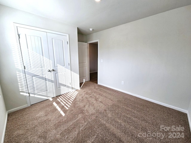 unfurnished bedroom with a closet and carpet