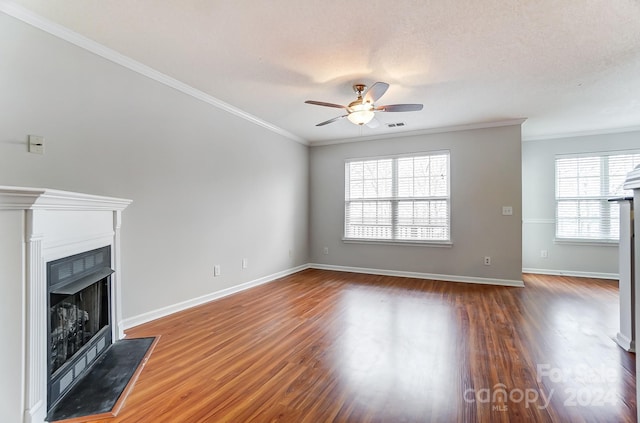 unfurnished living room featuring a textured ceiling, ceiling fan, wood-type flooring, and ornamental molding