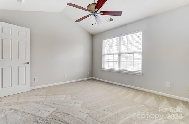 carpeted empty room with lofted ceiling and ceiling fan