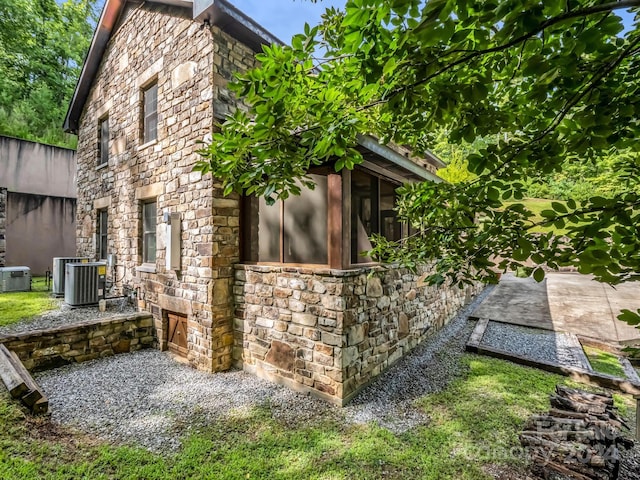 view of side of home featuring cooling unit