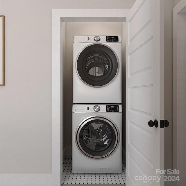 laundry area with tile patterned floors and stacked washer and clothes dryer