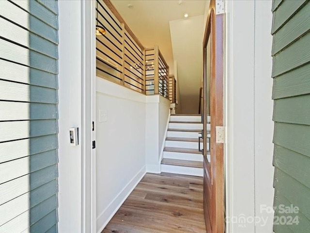 stairs with hardwood / wood-style flooring