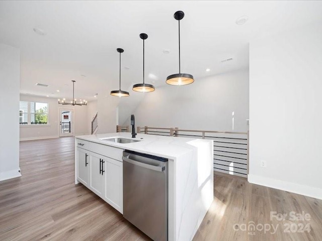 kitchen featuring light wood-type flooring, stainless steel dishwasher, a kitchen island with sink, sink, and white cabinetry