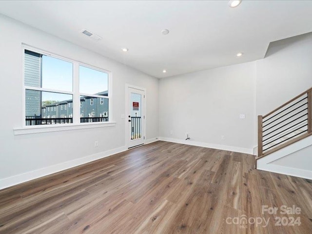 unfurnished living room featuring hardwood / wood-style flooring