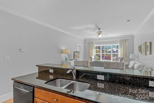 kitchen featuring dishwasher, ornamental molding, open floor plan, dark stone countertops, and a sink