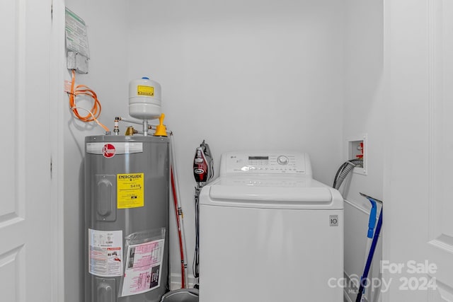 laundry room featuring water heater, laundry area, and washer / dryer