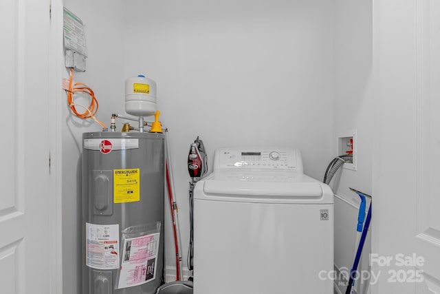 clothes washing area with water heater, laundry area, and washer / dryer