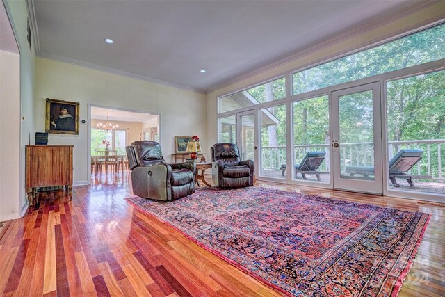 living room featuring a healthy amount of sunlight, hardwood / wood-style floors, and a chandelier