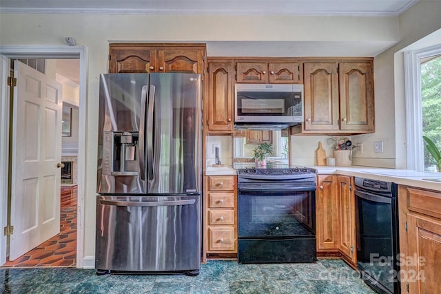 kitchen with crown molding and appliances with stainless steel finishes