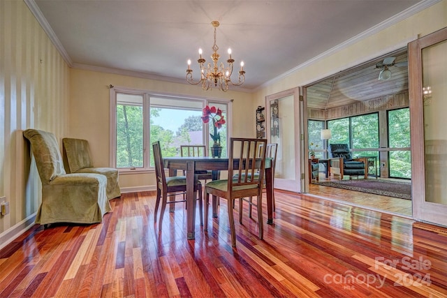 dining area featuring hardwood / wood-style floors, a notable chandelier, and ornamental molding