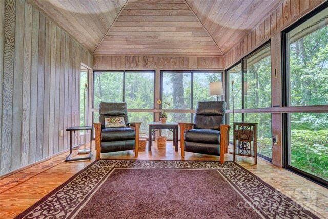 sunroom / solarium with vaulted ceiling, wood ceiling, and plenty of natural light