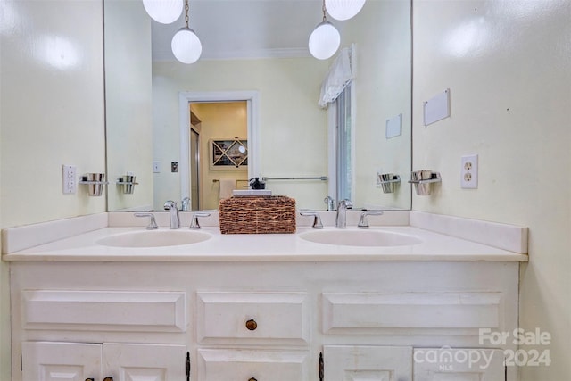 bathroom with ornamental molding and double sink vanity