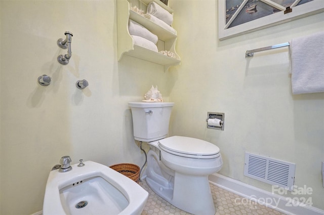 bathroom featuring a bidet and toilet