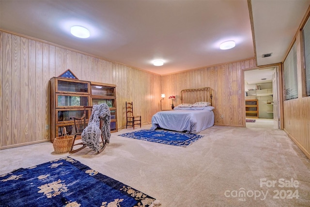 bedroom featuring carpet floors and wood walls