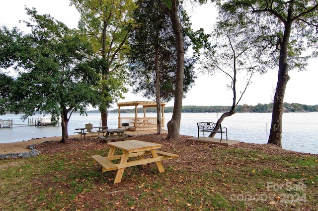 dock area featuring a pergola and a water view