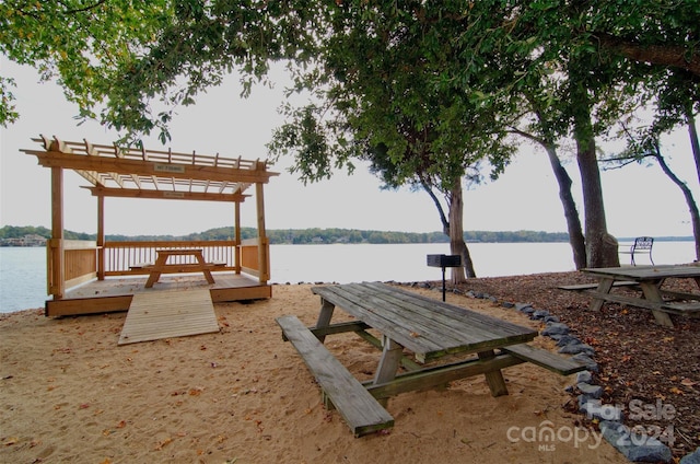 dock area featuring a water view and a pergola