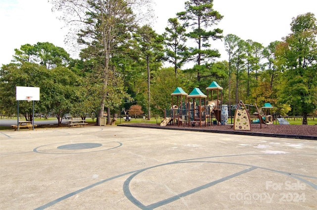 view of sport court with a playground