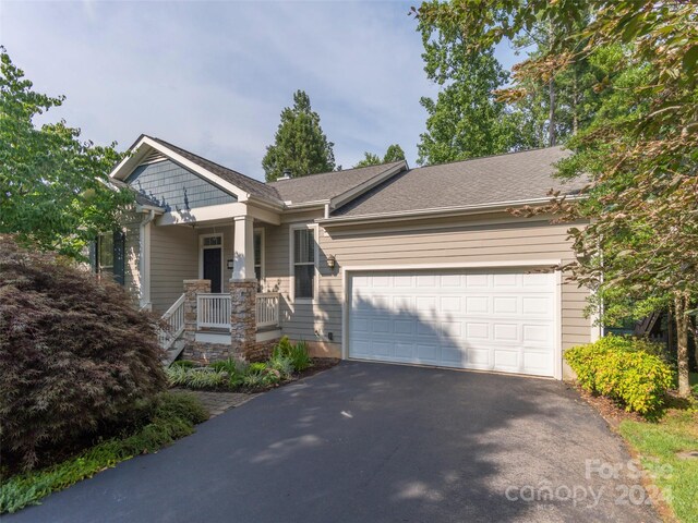 view of front of property featuring a porch and a garage