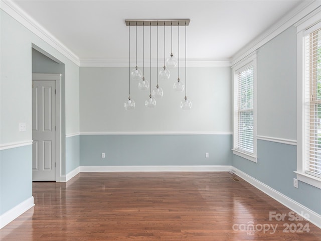 unfurnished room featuring hardwood / wood-style flooring and crown molding