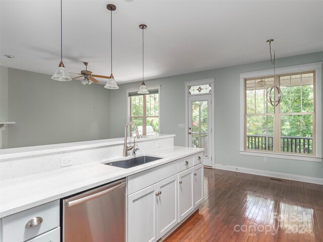 kitchen featuring dishwasher, decorative light fixtures, sink, and dark wood-type flooring