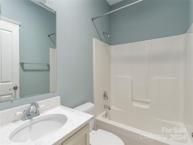 full bathroom featuring toilet, vanity, and tub / shower combination