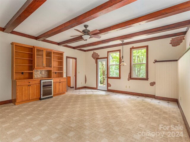 unfurnished living room with beverage cooler, light carpet, ceiling fan, and beam ceiling