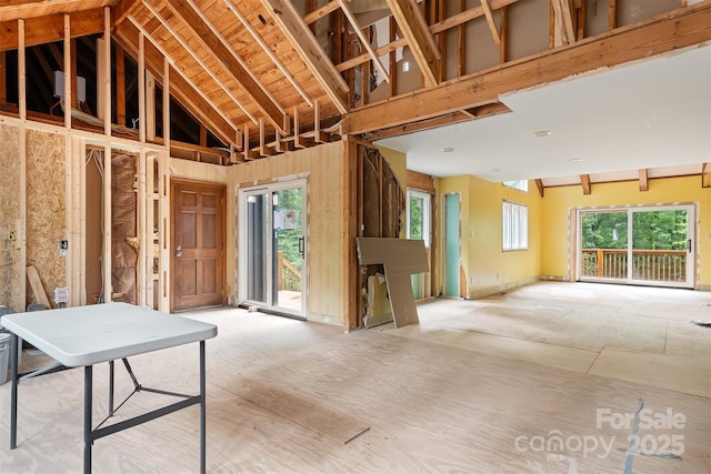 miscellaneous room with high vaulted ceiling and a healthy amount of sunlight