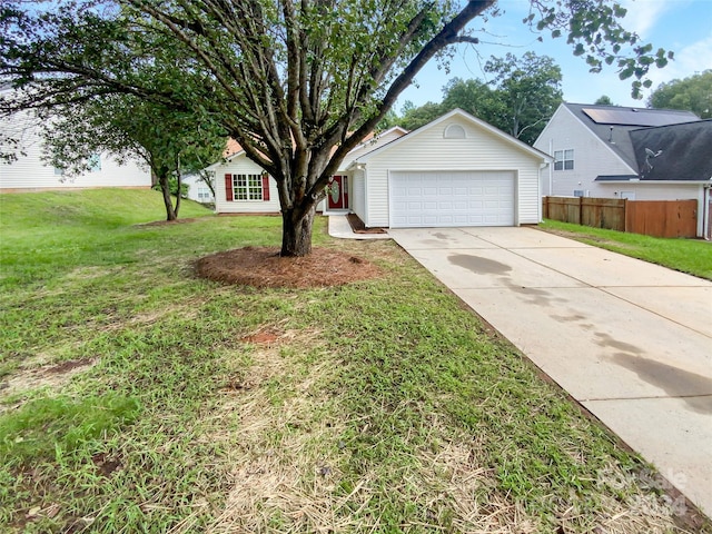 view of front of property with a garage and a front lawn