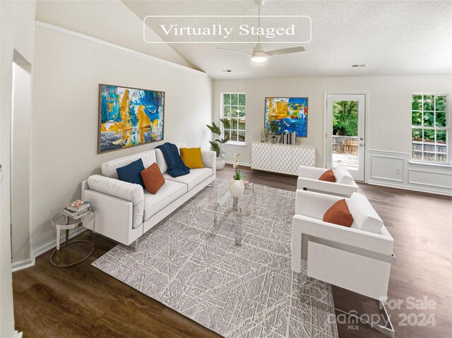 living room featuring a textured ceiling, wood-type flooring, ceiling fan, and lofted ceiling