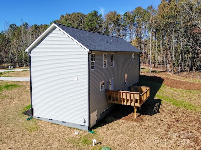 view of home's exterior with a yard and a deck