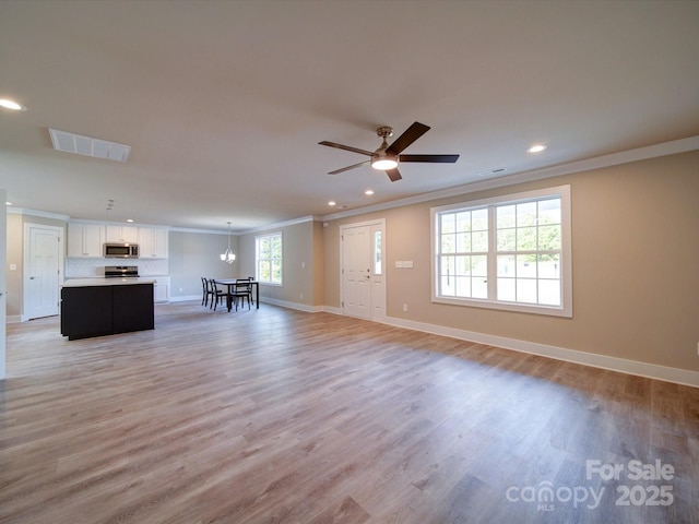 1133 Heather Oak Ln, Oakboro, NC 28129 - living area featuring crown molding, recessed lighting, baseboards, light wood-style floors, and ceiling fan