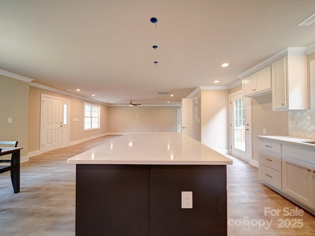 1133 Heather Oak Ln, Oakboro, NC 28129 - kitchen featuring crown molding, baseboards, ceiling fan, white cabinetry, and recessed lighting