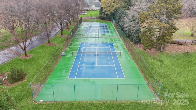 view of sport court featuring a lawn