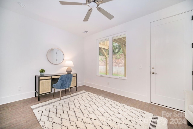 office with hardwood / wood-style flooring and ceiling fan