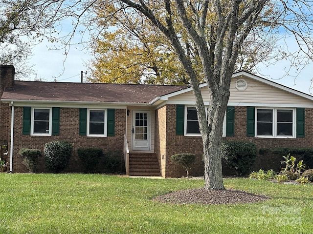 ranch-style home featuring a front yard