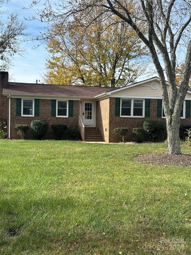 ranch-style house with a front lawn