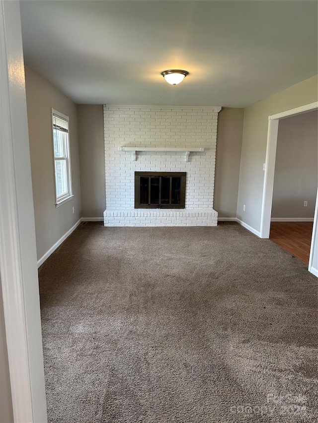 unfurnished living room featuring a fireplace and carpet flooring