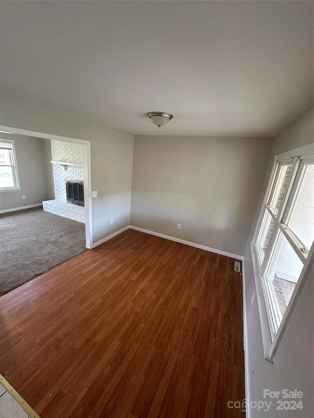 unfurnished living room with a fireplace and hardwood / wood-style floors