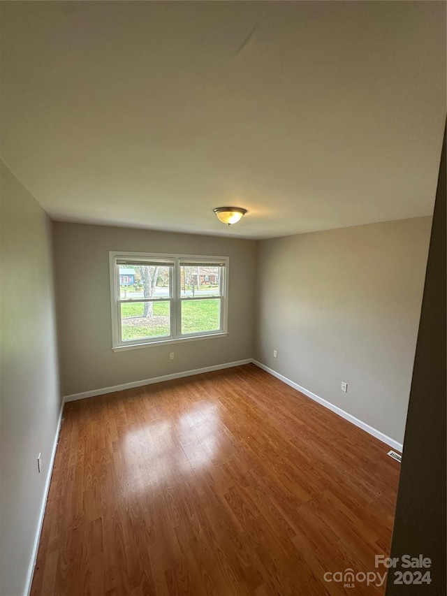 unfurnished room featuring wood-type flooring