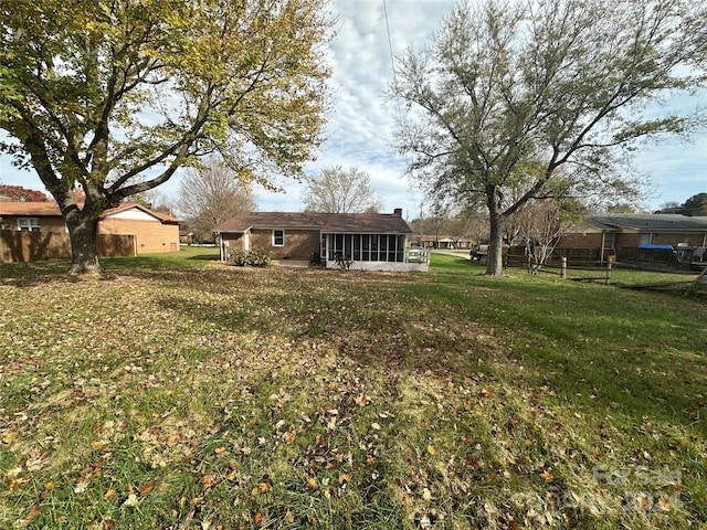 view of yard featuring a sunroom